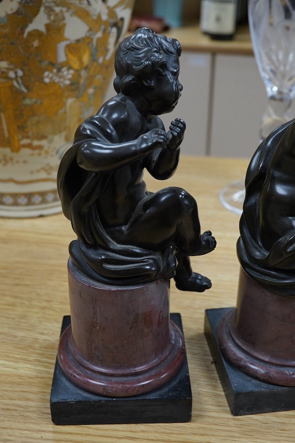 A pair of 19th century French bronze figures of children playing instruments, raised on rouge marble columns, 23cm high. Condition - poor